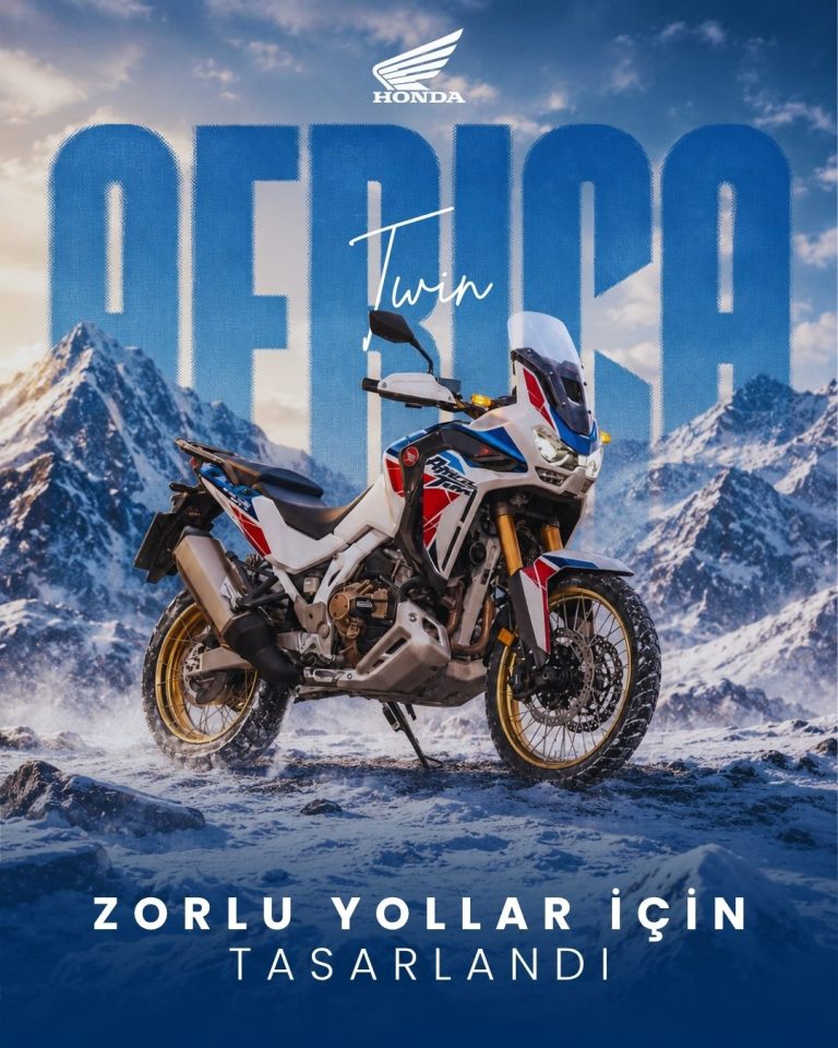 Karlı dağ manzarası önünde Honda Africa Twin motosiklet ve arka planda dev tipografi